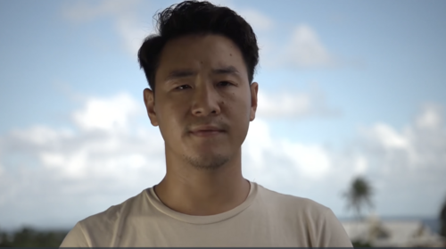 Solomon Yeo, a young man, looking at the camera outdoors